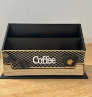 Black and gold coffee box with 'Coffee' text on a wooden surface