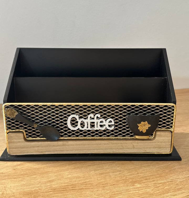 Black and gold coffee box with 'Coffee' text on a wooden surface