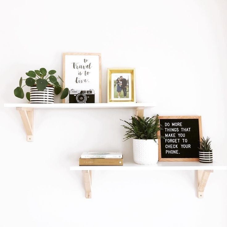 White wooden shelf with metal holder